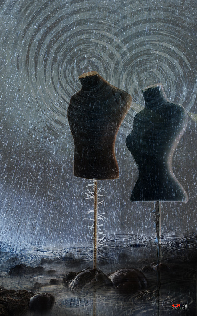 Two headless brown and blue mannequin torsos stand in heavy rain over rippling dark water. — illustrating “August Empties” on Florence and Mary