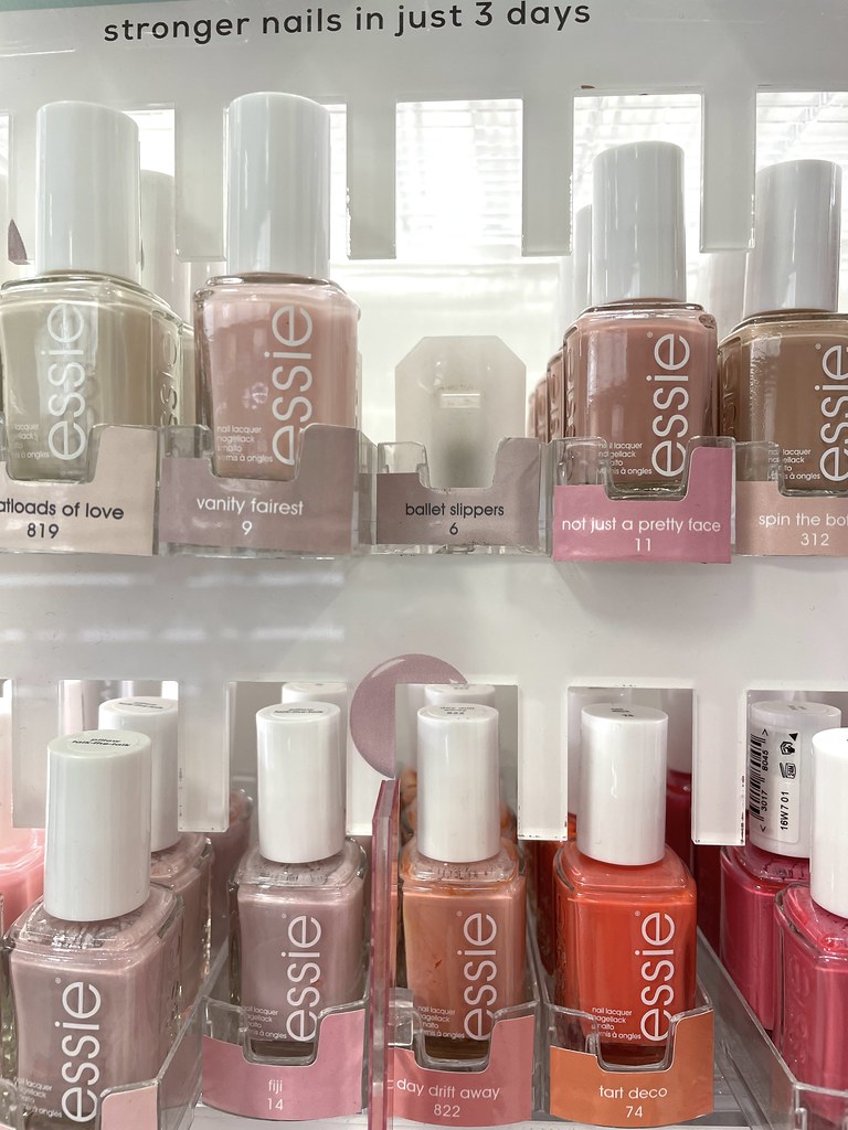 Rows of Essie nail polish bottles in pink, nude, and coral shades sit on a white retail shelf. — illustrating “Barry M Jelly Nails Review” on Florence and Mary