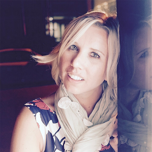 A blonde woman in a lace-trimmed pale scarf and navy floral dress smiles against a dark reflective surface. — illustrating “BEDM: Pets” on Florence and Mary