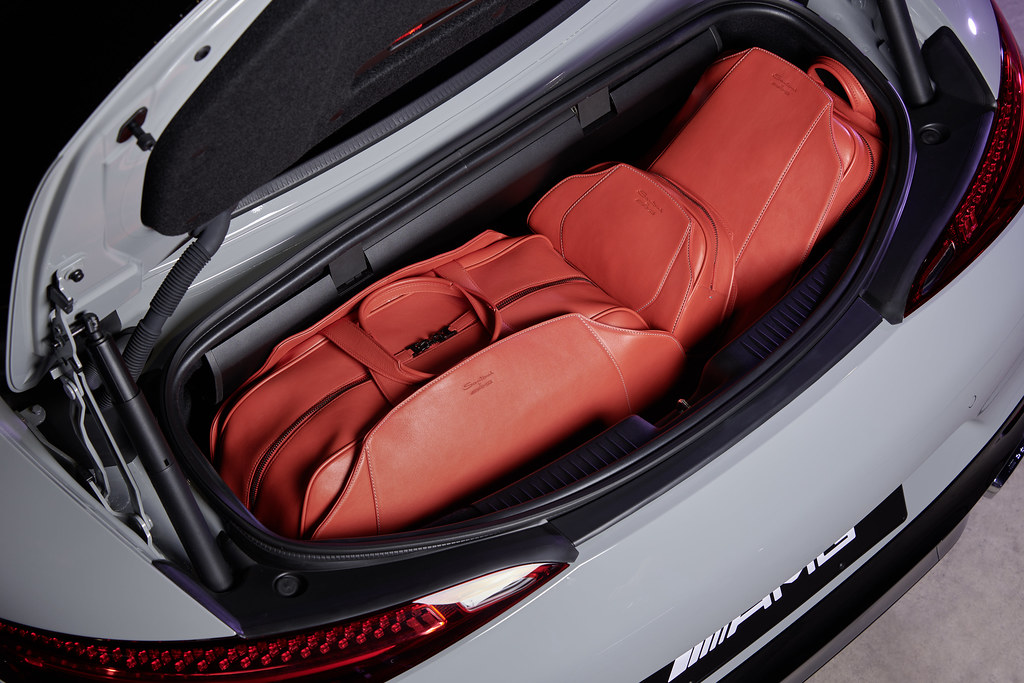 Three bright red leather travel bags sit neatly packed in the open trunk of a light gray AMG car. — illustrating “Boots Beauty Haul” on Florence and Mary