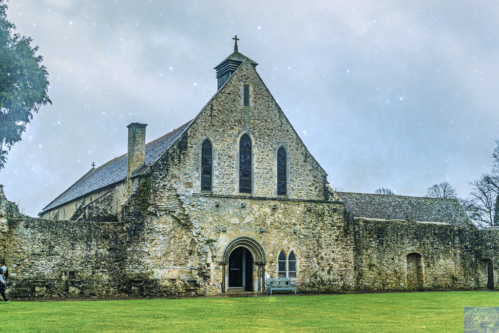 An ancient stone building with arched windows stands behind a green lawn under a pale speckled blue sky. — illustrating “Brace Face The end is near” on Florence and Mary