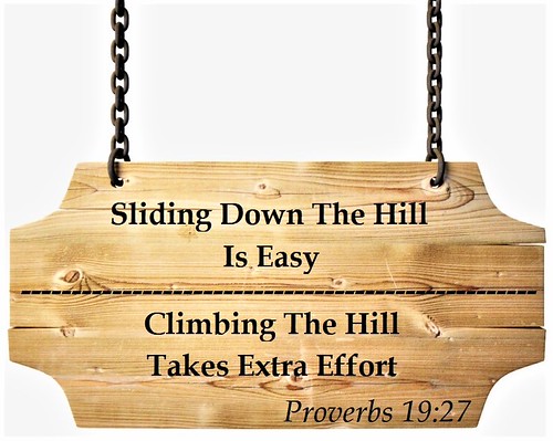 A light wooden hanging sign quotes climbing hill effort with Proverbs 19:27 against a plain white backdrop. — illustrating “His Heaven Skincare Men's Christmas Gift Ideas” on Florence and Mary