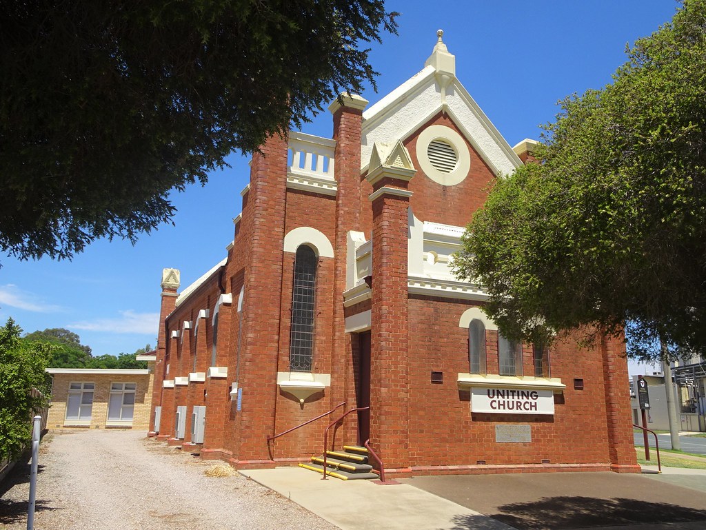 A red brick Uniting Church with white gables and arched windows stands under a clear bright blue sky. — illustrating “House of Rush // Elemis Facial & Essie Manicure” on Florence and Mary