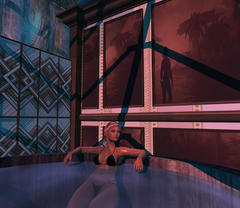 A blonde avatar in a black bikini reclines in a steaming wooden hot tub before palm-tree wall art. — illustrating “July Favourites” on Florence and Mary
