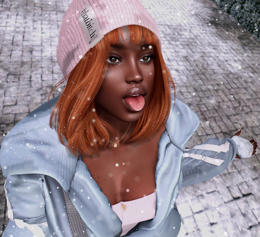 A digital avatar with orange hair and pink beanie sticks out their tongue in falling snow. — illustrating “Nails Inc Dry & Damaged Nails Kit” on Florence and Mary