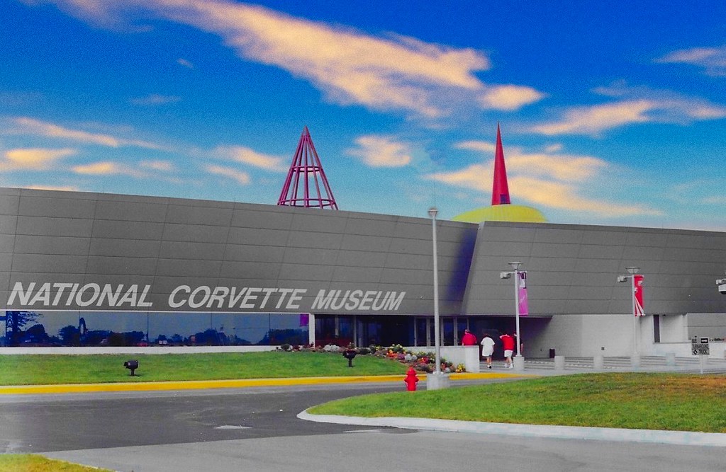 National Corvette Museum exterior with gray facade, red spires, and a colorful sunset sky. — illustrating “November Empties” on Florence and Mary
