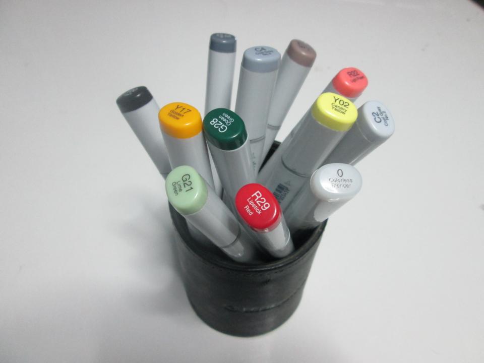 Gray markers with colorful labeled caps sit in a black container on a white surface. — illustrating “Review // Lush Popcorn Lip Scrub” on Florence and Mary