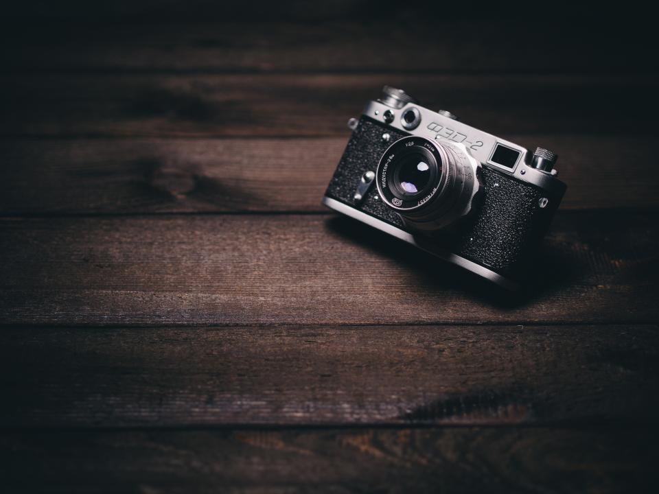 Vintage black and silver rangefinder camera sits on dark brown wooden planks in soft light. — illustrating “Super Gorgeous September // Photo-a-Day Challenge” on Florence and Mary