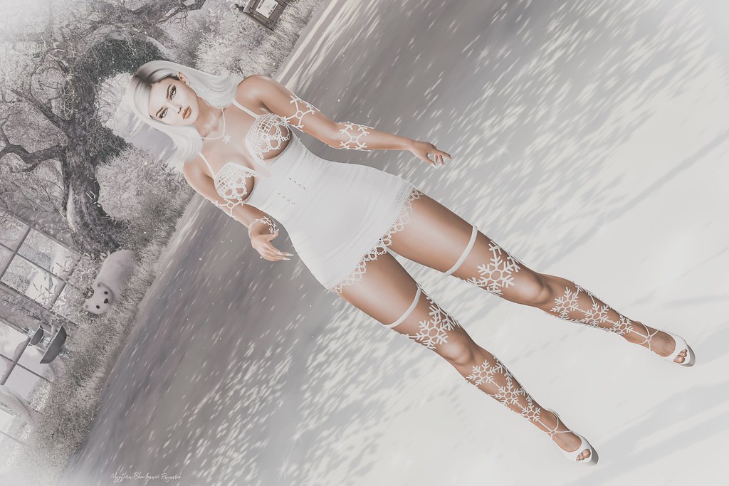 Digital avatar with platinum hair in white lace dress and snowflake leg wraps in a bright winter scene. — illustrating “The Christmas Tree Debate” on Florence and Mary
