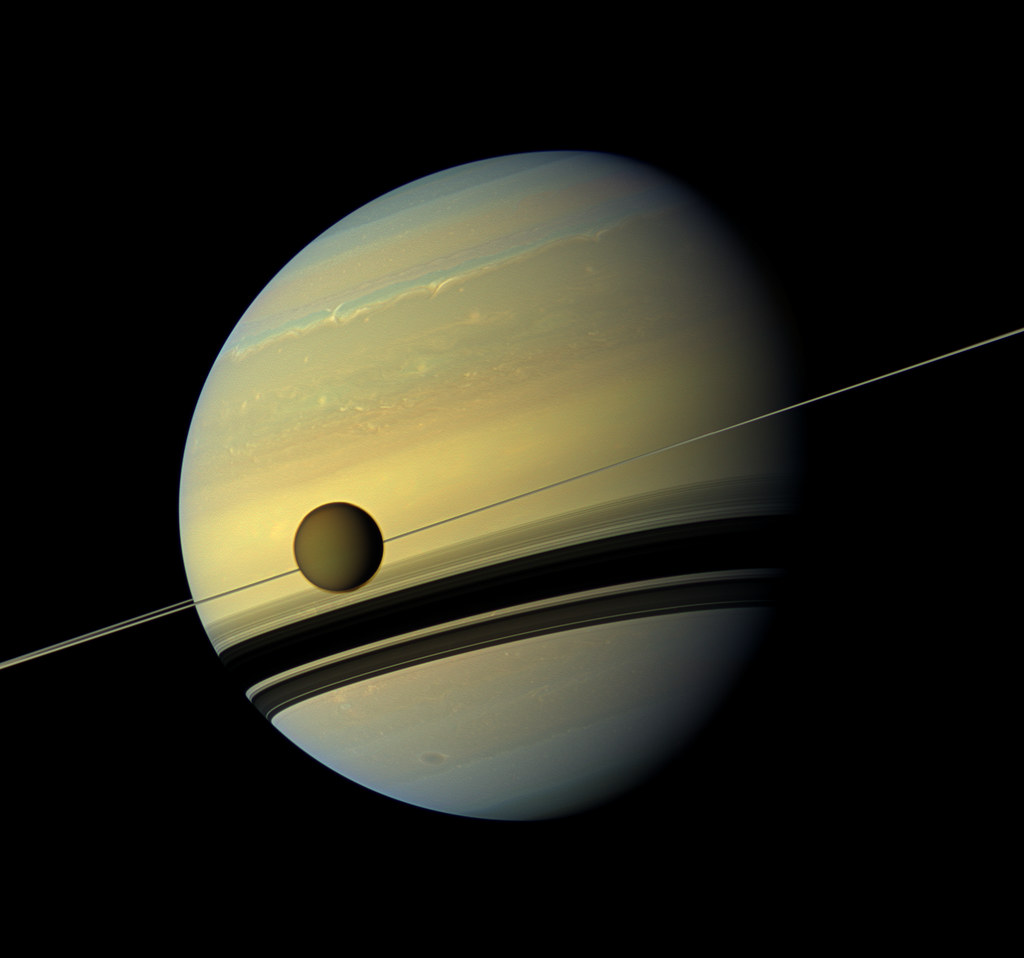 High-resolution Saturn with atmospheric bands, thin rings, and a small moon against black space. — illustrating “The Impossible” on Florence and Mary