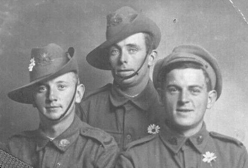 Black-and-white photo of three uniformed men, two in slouch hats, one with white flower on collar. — illustrating “The Single Girls Date Night #1” on Florence and Mary