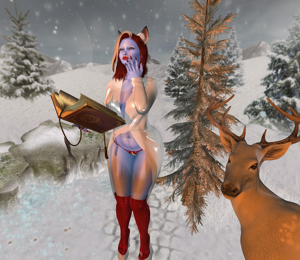 A blue-skinned woman with fox ears holds an open book beside an antlered deer in snow. — illustrating “Wet & Wild Fergie Palette in Desert Festival Review” on Florence and Mary