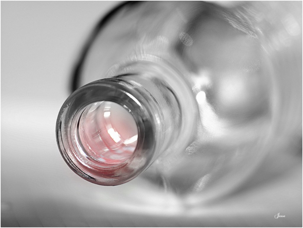 A monochrome close-up of a clear glass bottle neck with a soft pink glow inside. — illustrating “What I got for Christmas 2013 | For the Home” on Florence and Mary