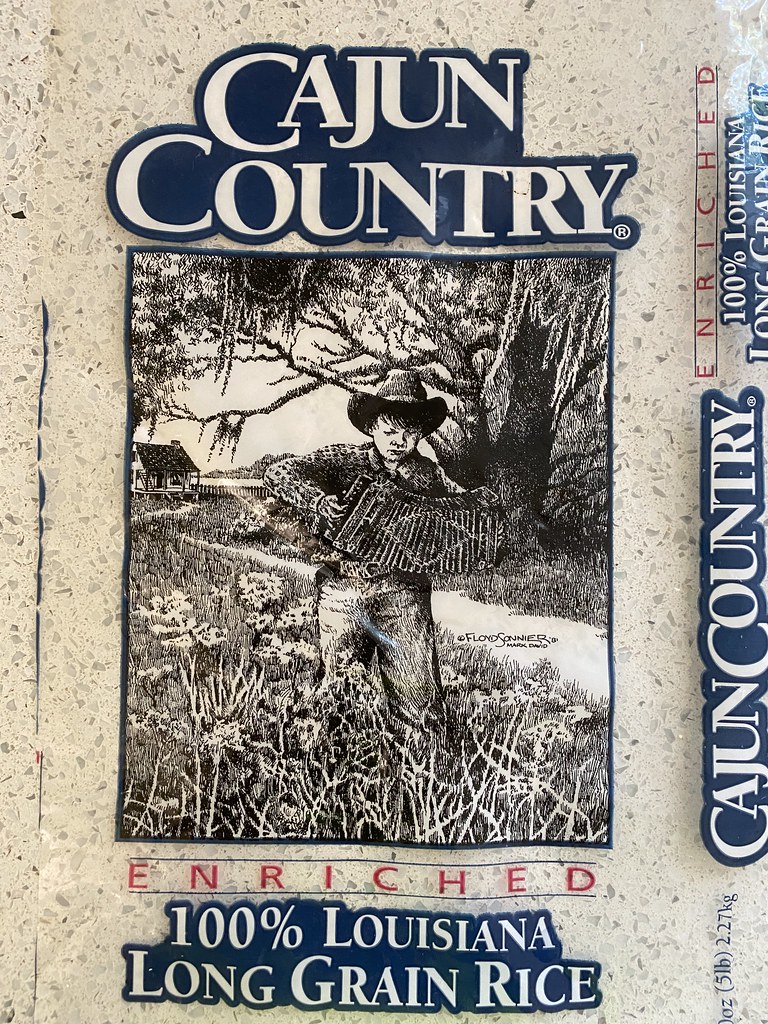 A Louisiana long grain rice bag shows a blue Cajun Country logo and accordion player sketch. — illustrating “What's in my bag | Sightseeing Essentials” on Florence and Mary